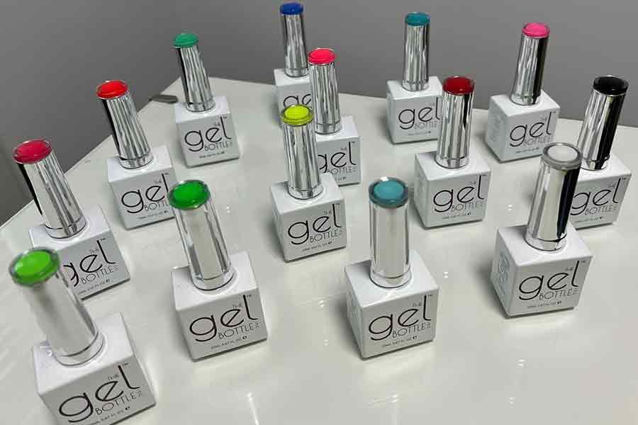 different coloured bottels of GEl nail polish on a table