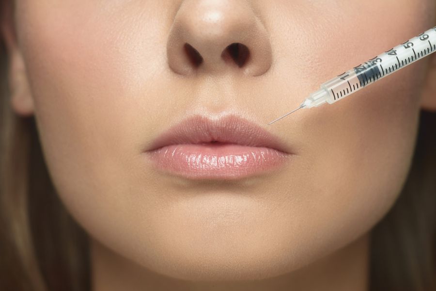 woman having a lip filler injection