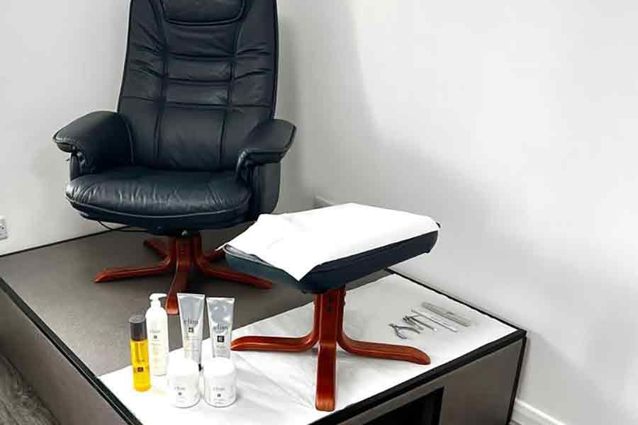 pedicure ststion with a chair, stool and products