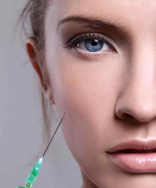 beauty model with injection next to her face