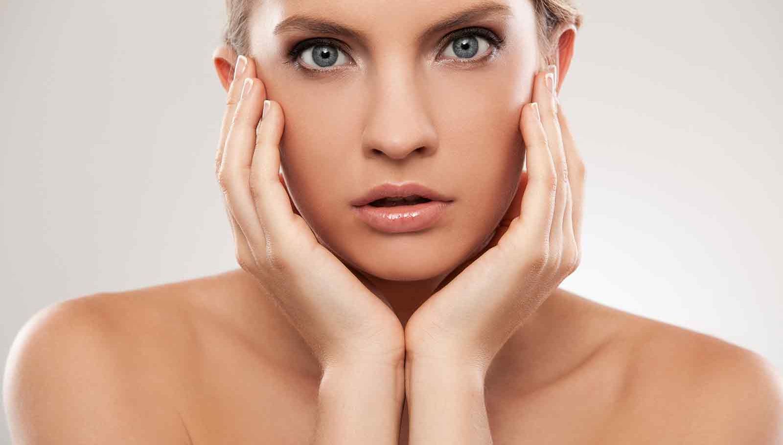 Model with her hands on her face looking at the camera