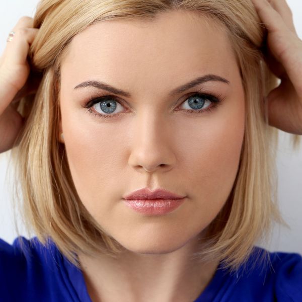 girl with perfect skin holding her hair